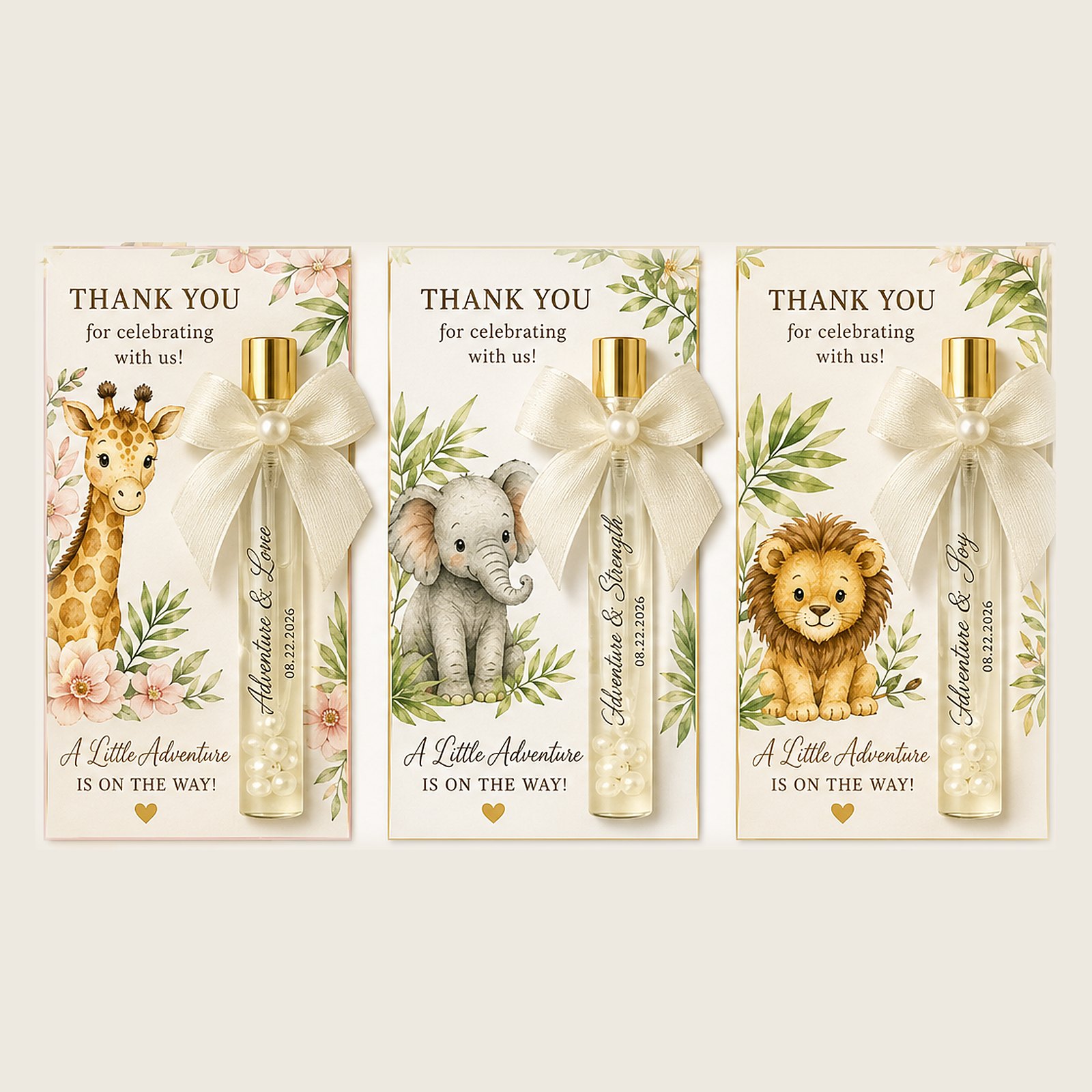 Three safari perfume favor cards for Baby LeGrand — giraffe, elephant and lion in watercolor — each with a gold-capped glass vial, an ivory satin bow with a pearl center, and the words 'Adventure & Love', 'Adventure & Strength' and 'Adventure & Joy'.